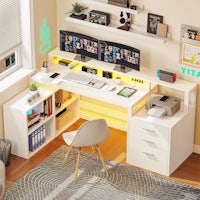 a white computer desk with two monitors and a chair