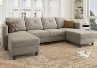 a sectional sofa with ottoman in a living room