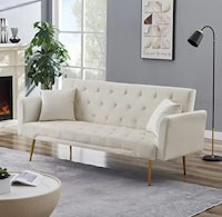 a white sofa in a living room with a fireplace